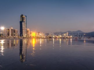 Strand coastline of buildings with a beautiful reflections in the wet sand